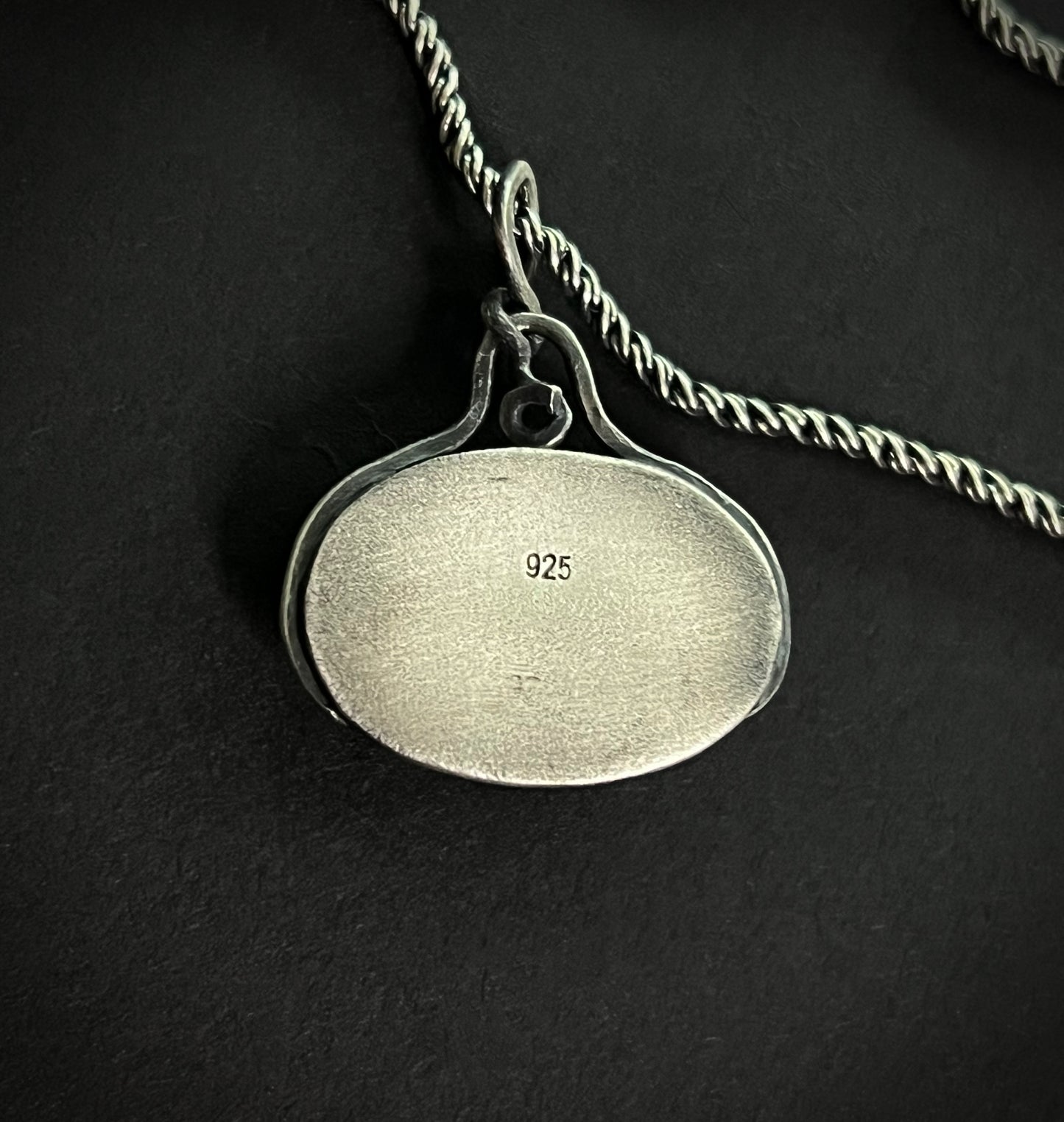 Back view of the Liath Pendant showing the polished silver surface with a 925 sterling silver hallmark stamp.