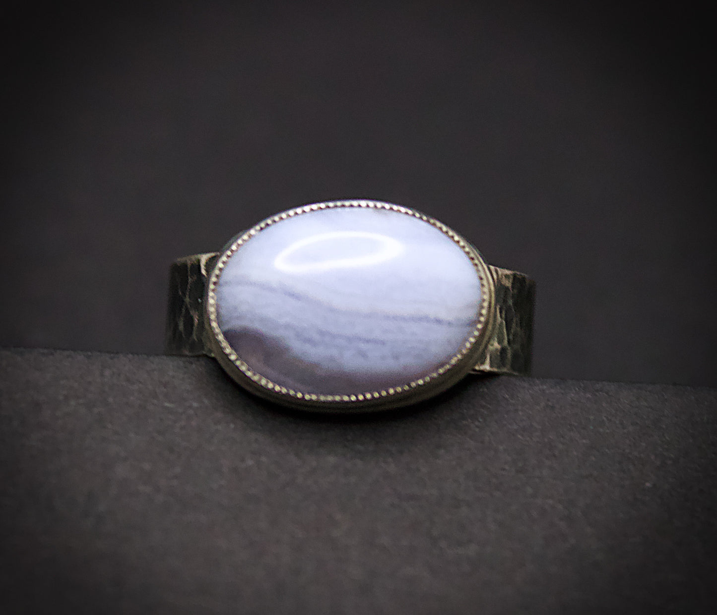 Ring with a large oval stone on a dark background