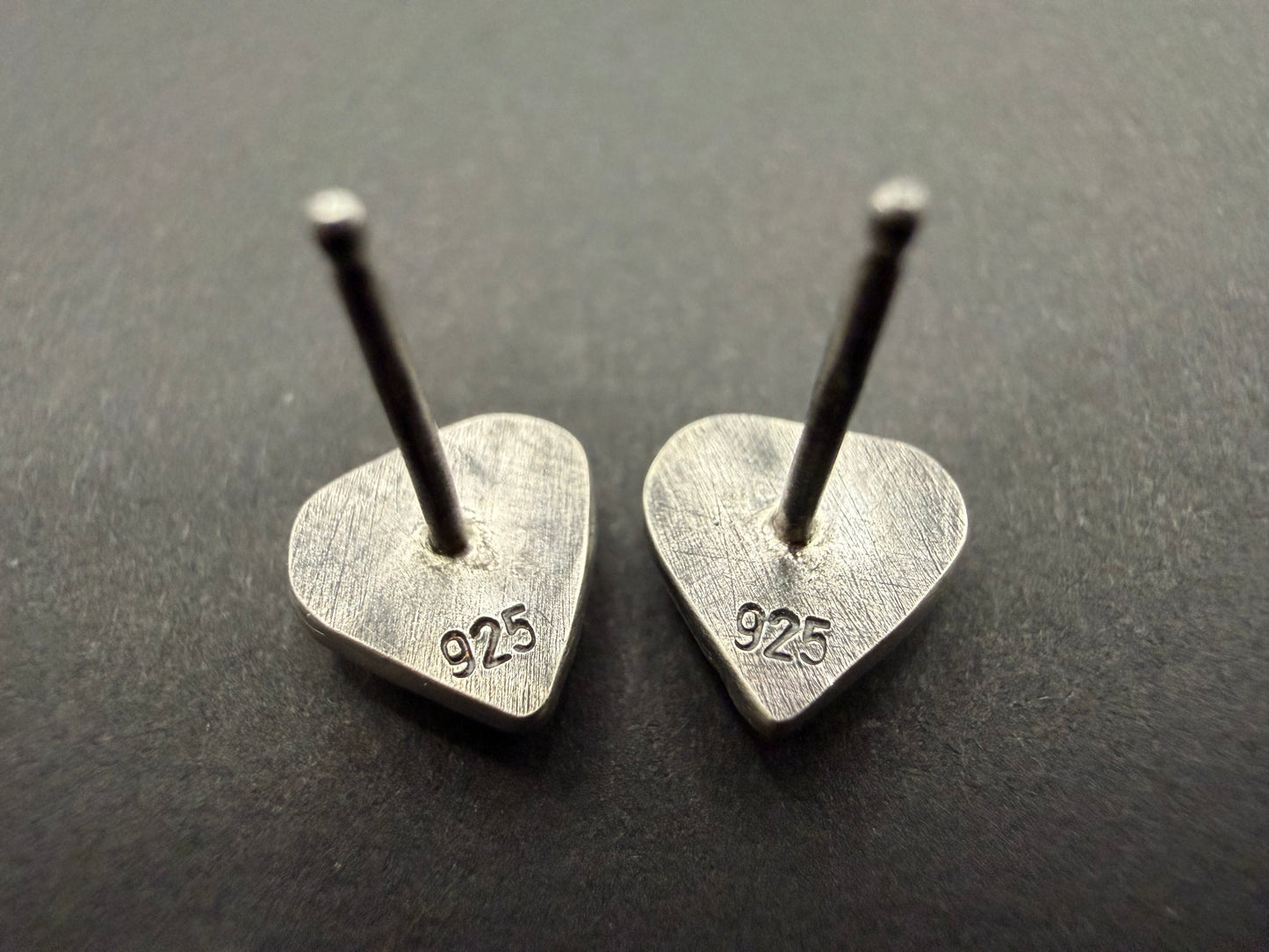 Back view of Ashborn sterling silver studs showing the 925 hallmark stamp on the flat, brushed silver surface with sterling silver posts.
