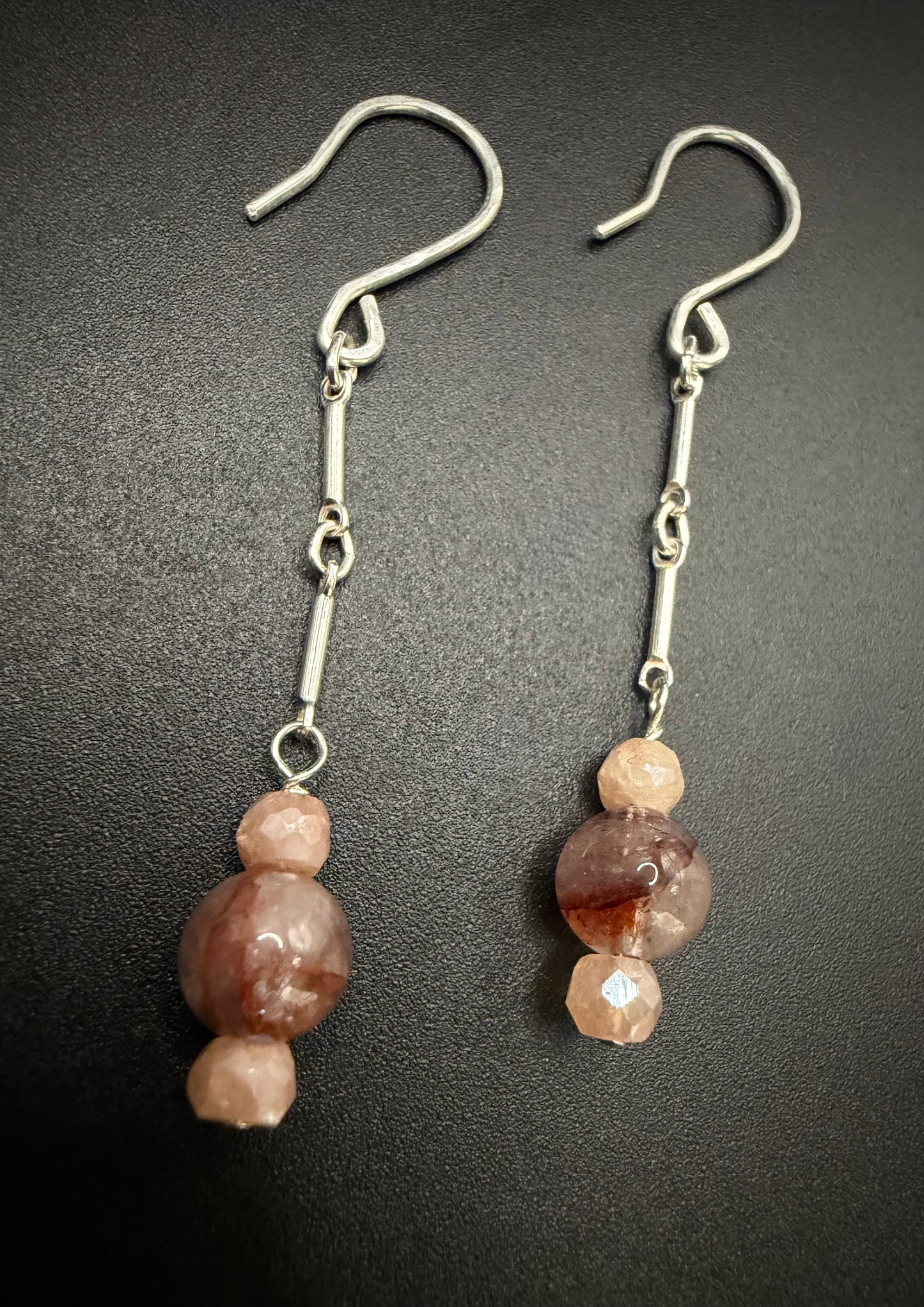 Handcrafted sterling silver drop earrings featuring a stack of faceted peach moonstone and earthy red agate beads on a silver chain.