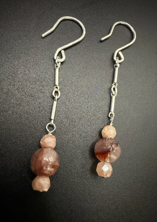 Handcrafted sterling silver drop earrings featuring a stack of faceted peach moonstone and earthy red agate beads on a silver chain.