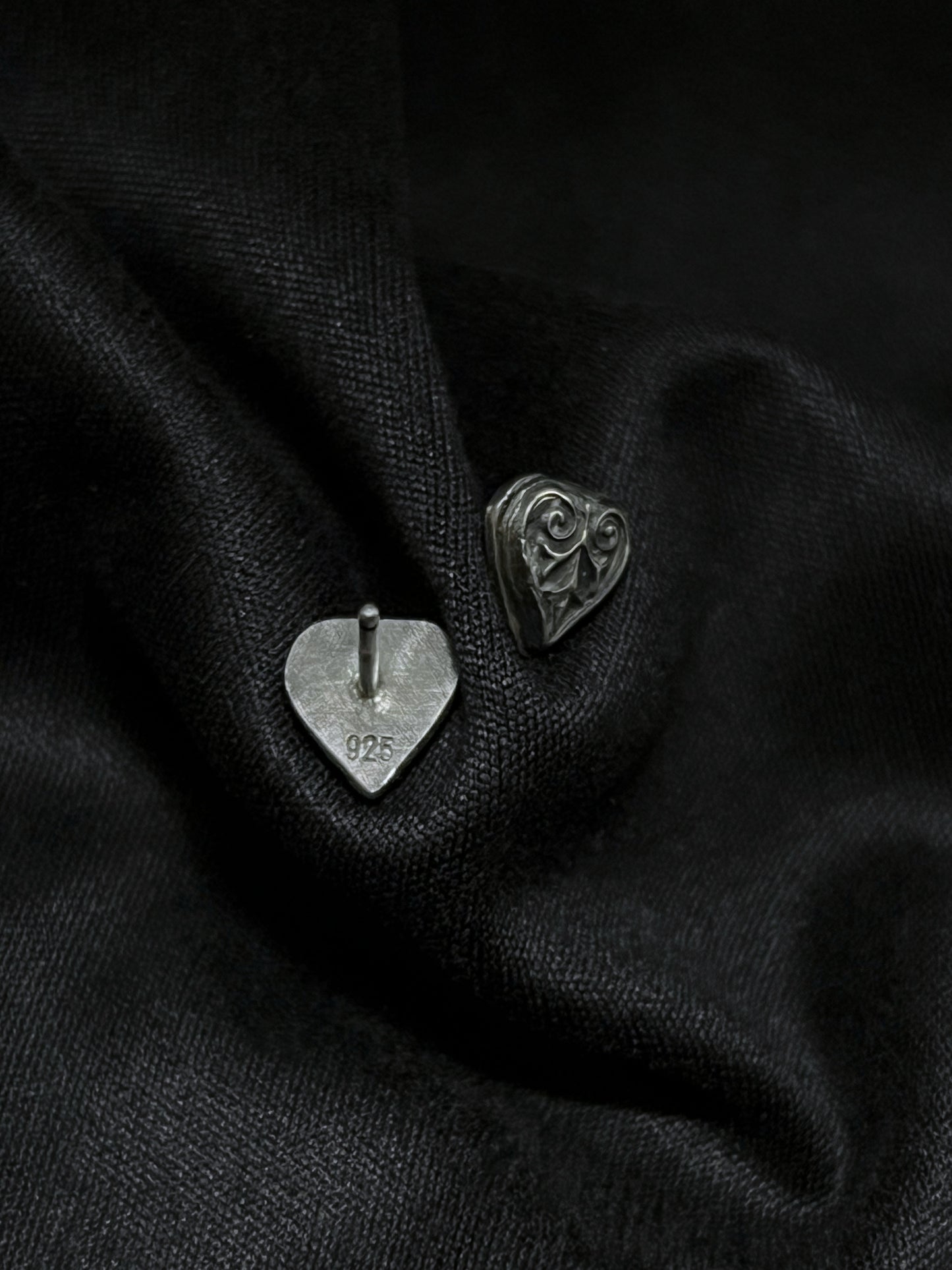 Back and front view of Ashborn sterling silver studs on black fabric, showing the 925 hallmark and the polished vintage scrollwork with dark patina.