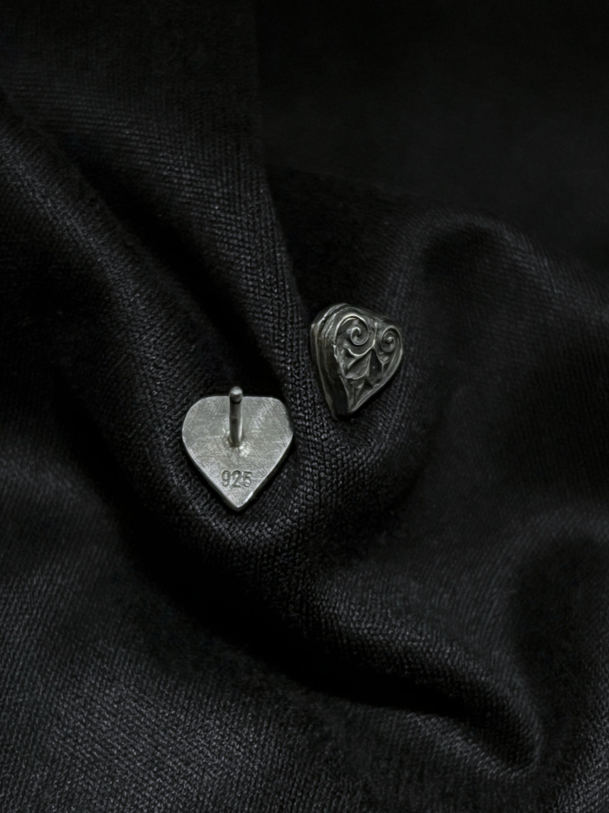 Back and front view of Ashborn sterling silver studs on black fabric, showing the 925 hallmark and the polished vintage scrollwork with dark patina.