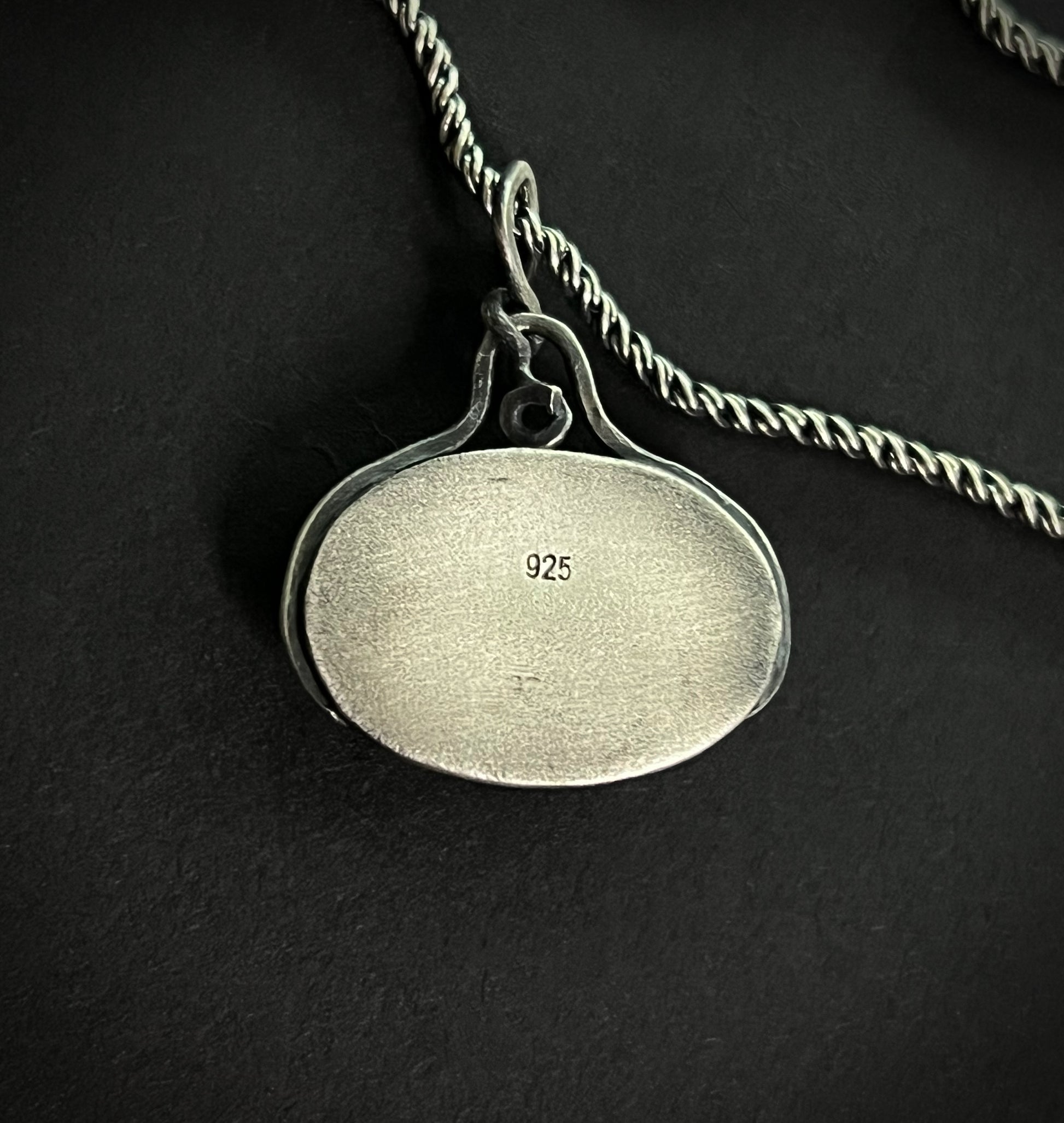 Back view of the Liath Pendant showing the polished silver surface with a 925 sterling silver hallmark stamp.